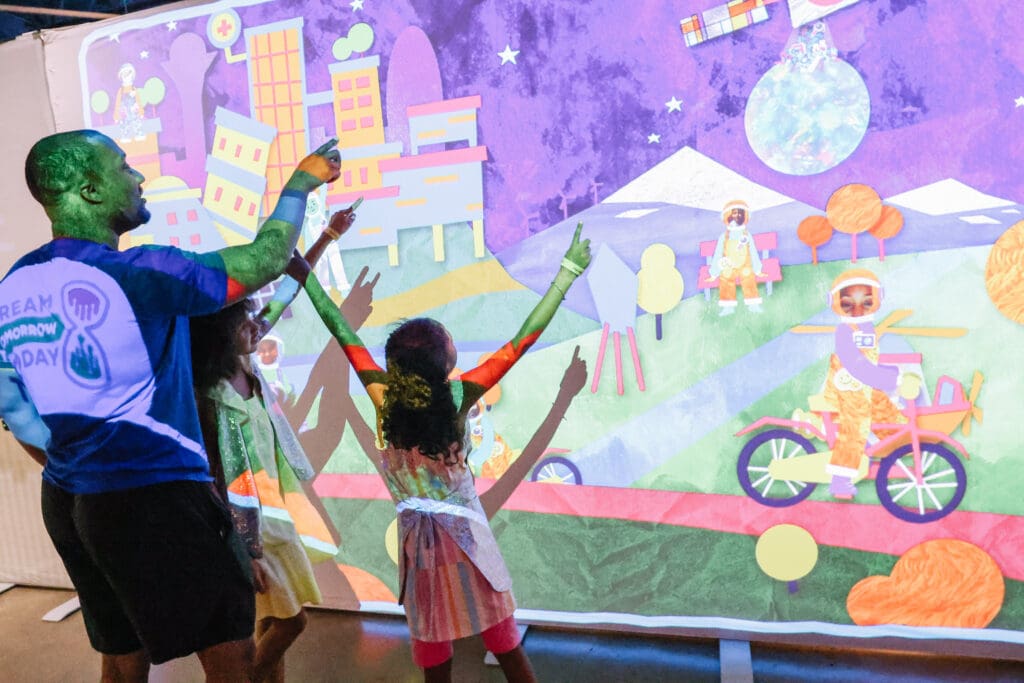 Children interacting with colorful projections.