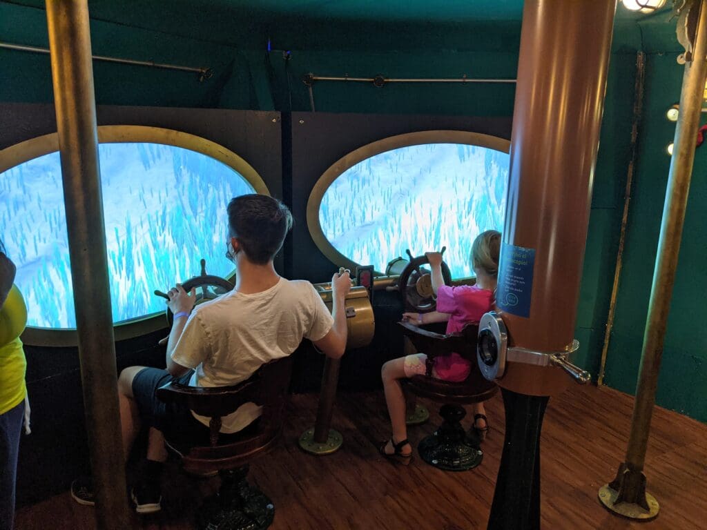 Children steering a simulated submarine