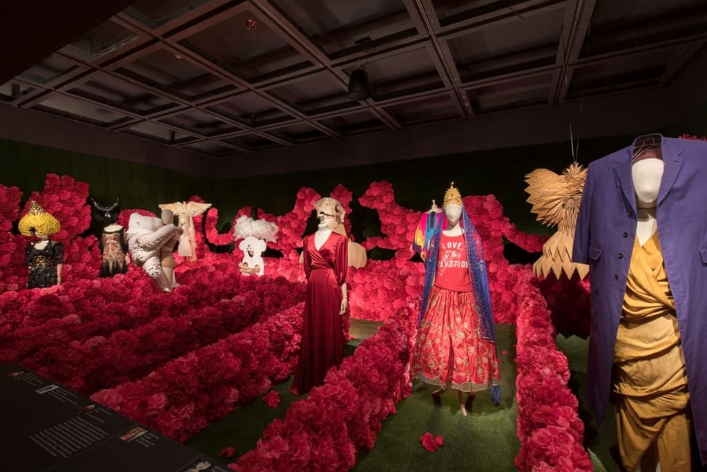 a room with mannequins and flowers