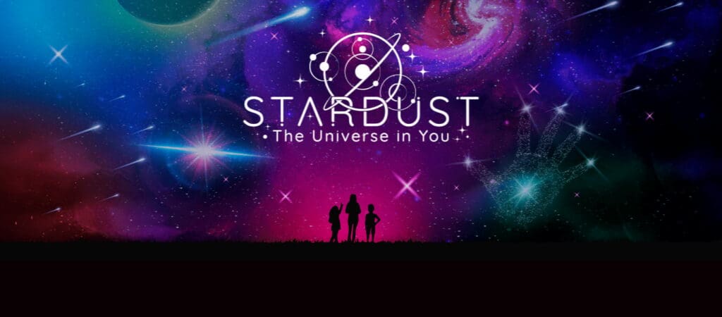 Silhouettes of three people stand under a colorful, star-filled galaxy sky with the text "STARDUST: The Universe in You," as Flying Fish expands its reach with The Exhibitions Group and cosmic illustrations glow above them.