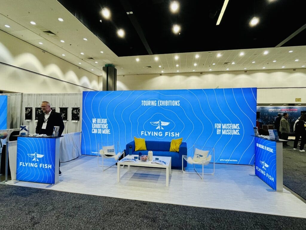 Jay standing behind the Flying Fish booth at AAM 2025